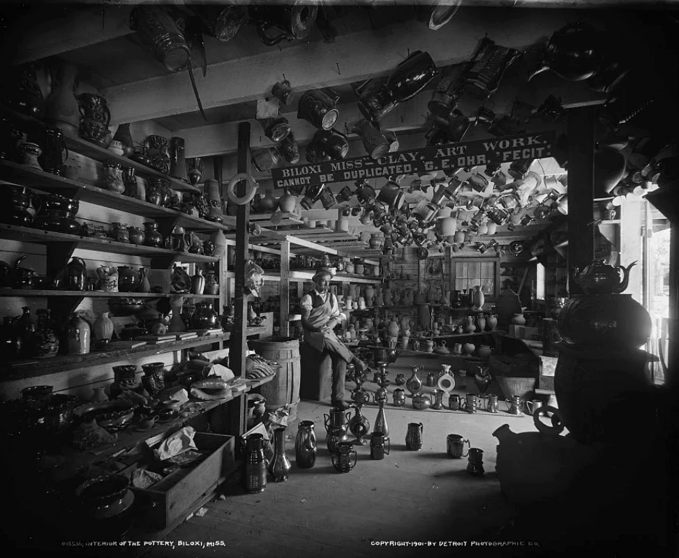 Shelves and hanging vessels crowd George Ohr’s pottery workshop in Biloxi