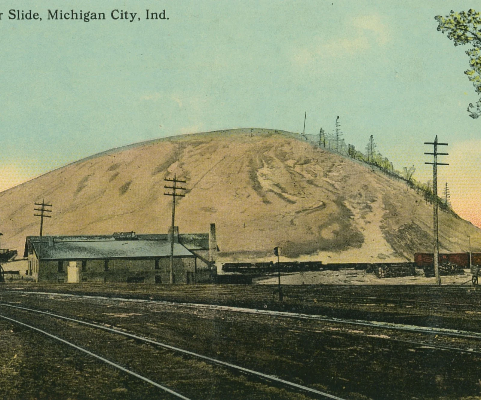 Large sand dune behind the waterfront railroad tracks in Michigan City in a 1907 postcard