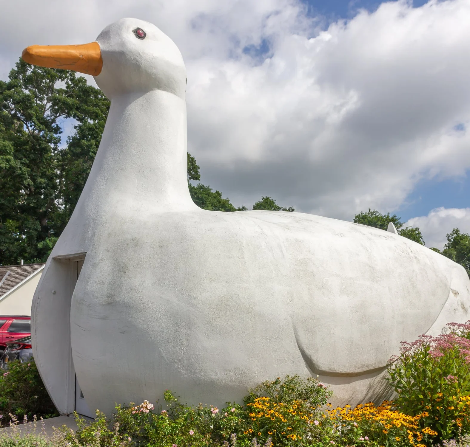 White duck-shaped roadside building with an orange beak in Flanders, New York