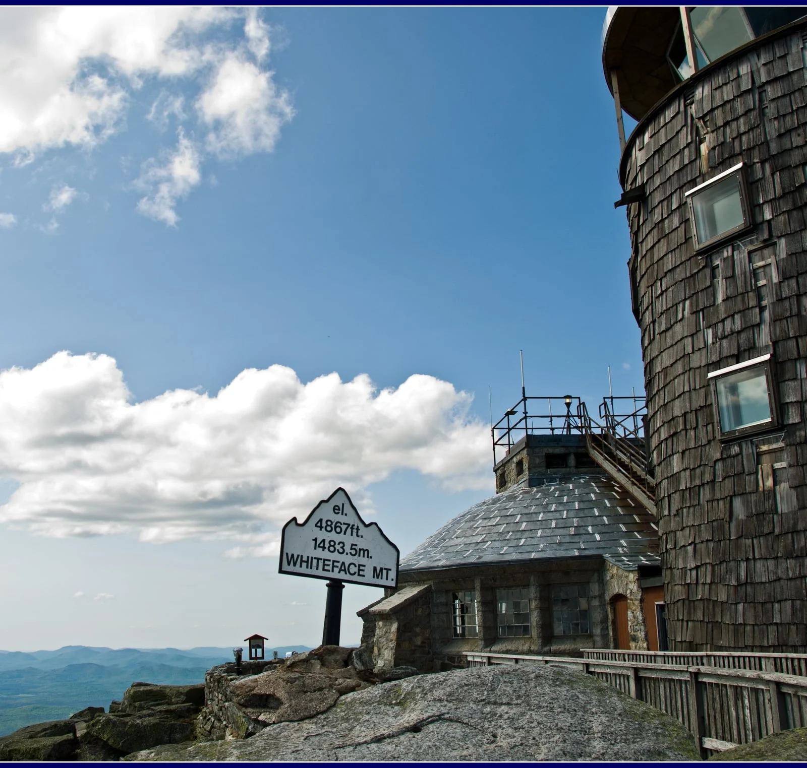 Stone Whiteface Castle beside the upper highway and a mountain elevation sign